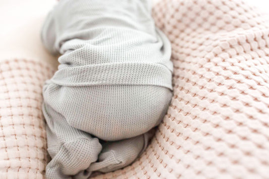 Newborn back flap footie onesie, soft waffle knit baby pajamas, baby boy infant outfit designed for comfortable overnight and daytime diaper changes.