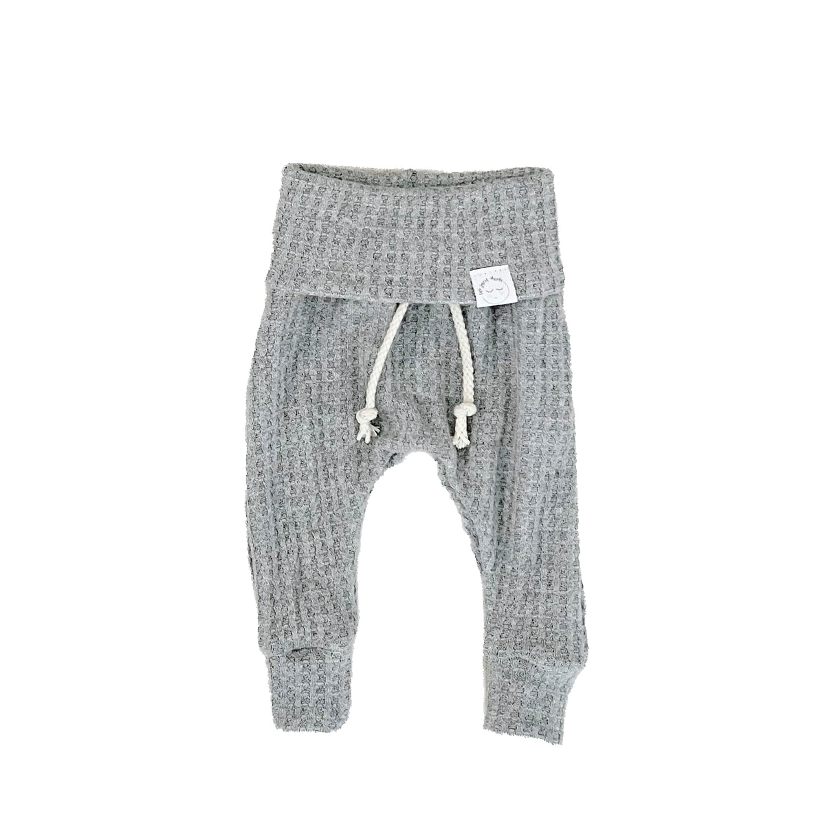 A pair of gray waffle-knit baby pants with a drawstring waist and ankle cuffs