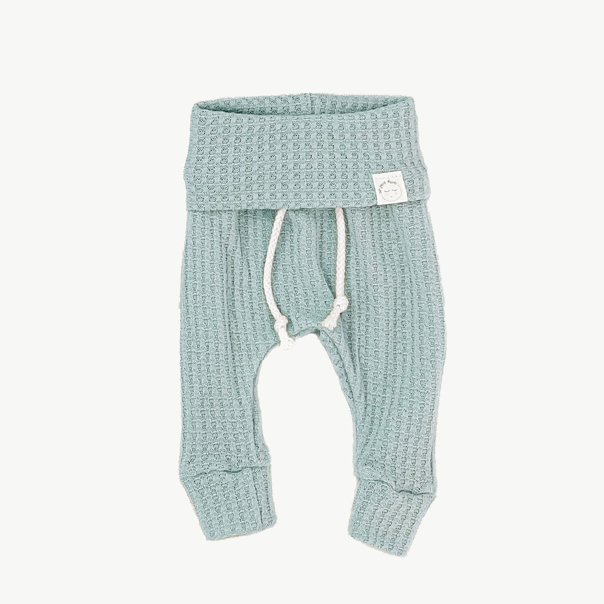 A pair of mint blue waffle-knit baby pants with a drawstring waist and ankle cuffs