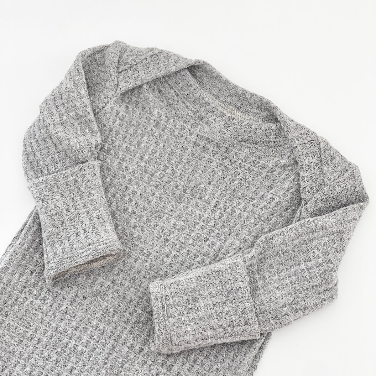 A light gray waffle-knit long-sleeve gown with a crew neck