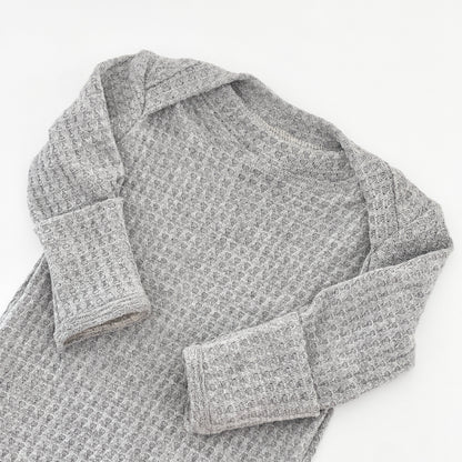 A light gray waffle-knit long-sleeve gown with a crew neck