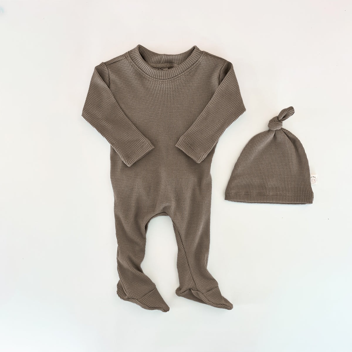 Baby footed sleeper in a textured taupe-brown waffle knit