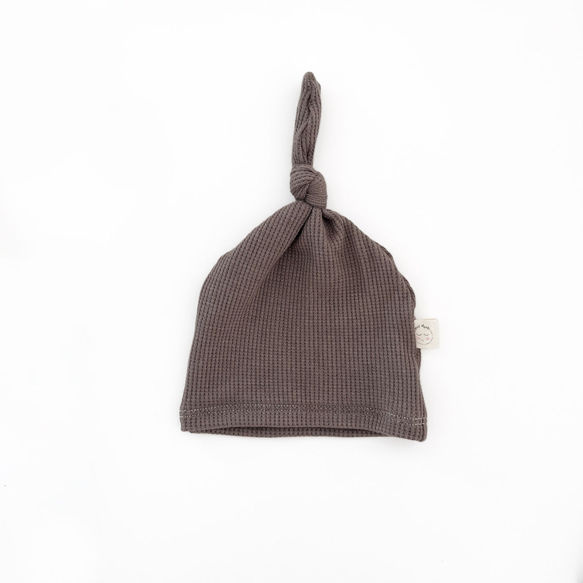 a handmade soft brown newborn knotted hat