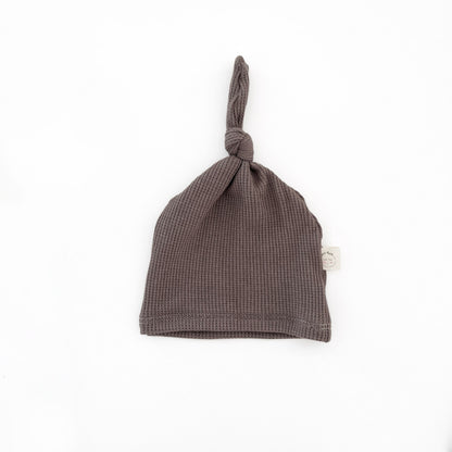 a handmade soft brown newborn knotted hat