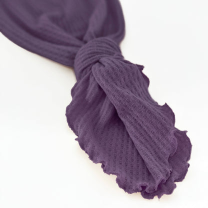 Two Sweet Cheeks plum purple waffle knit baby gown with an adjustable knotted bottom for easy diaper changes.