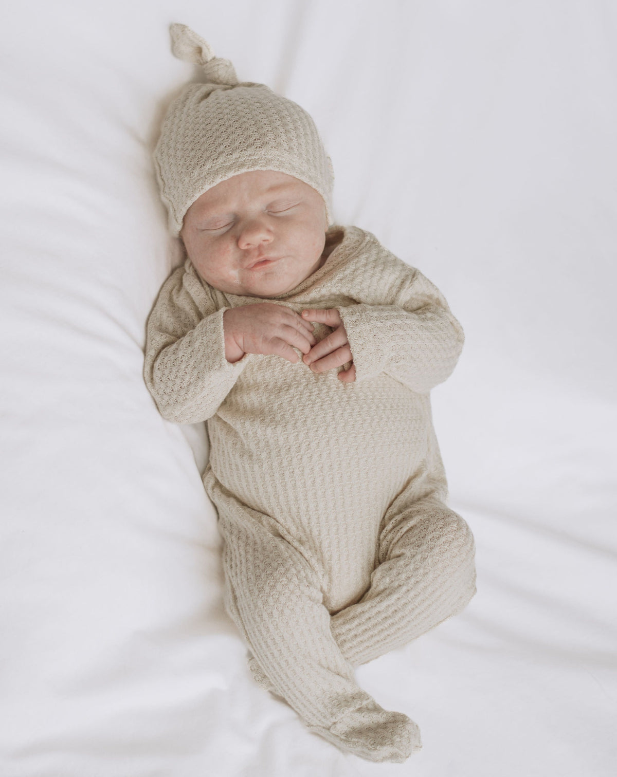 cream newborn waffle knit footie pajamas