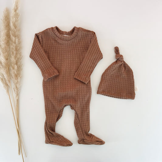 brown camel back flap footie for babies with a matching brown hat.
