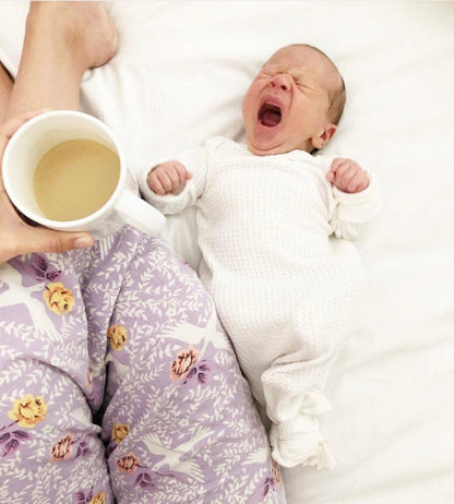 newborn white knotted baby gown