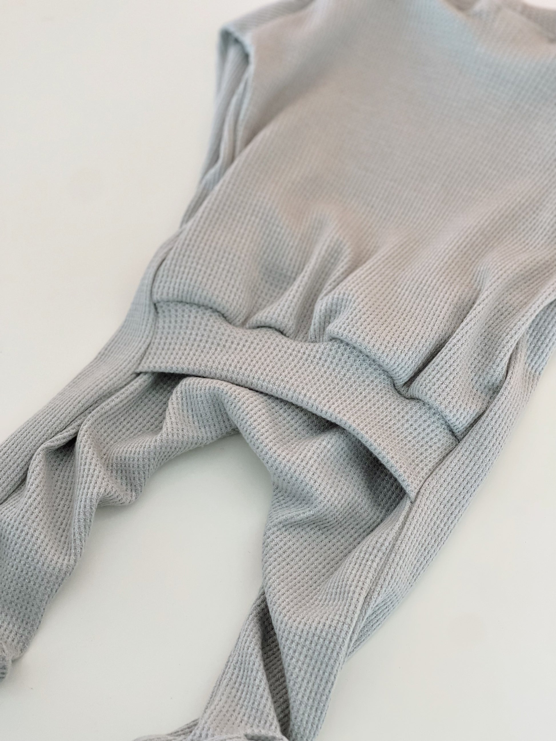 light blue baby boy onesie with a back flap for nighttime changing.