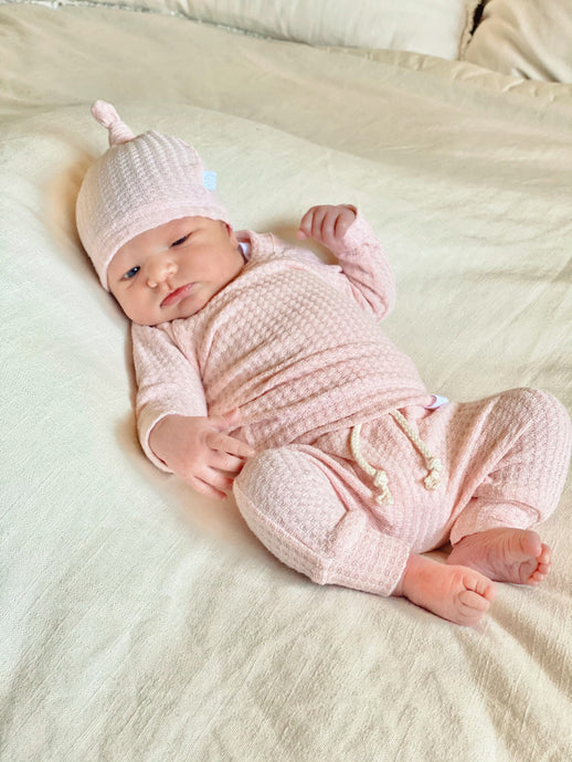 Newborn in soft pink waffle baby outfit, cozy knit romper for baby girls, baby girl shower gift.