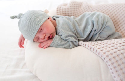 Soft and lightweight waffle knit baby footie with back flap, ideal for newborns, practical one-piece outfit for easy diaper changing and sleeping.