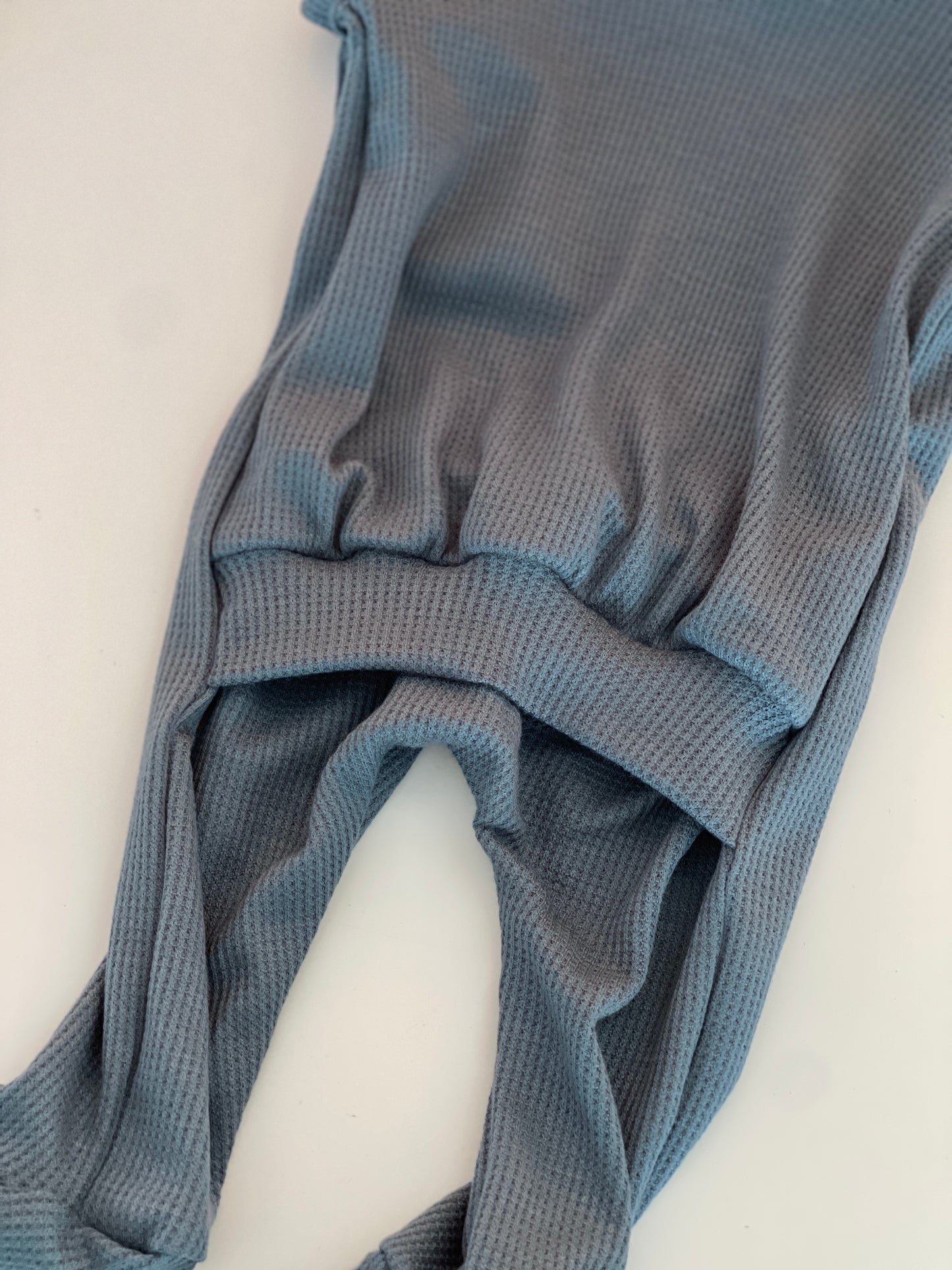 Soft and lightweight thermal back flap footie for babies, teal blue baby pajamas.