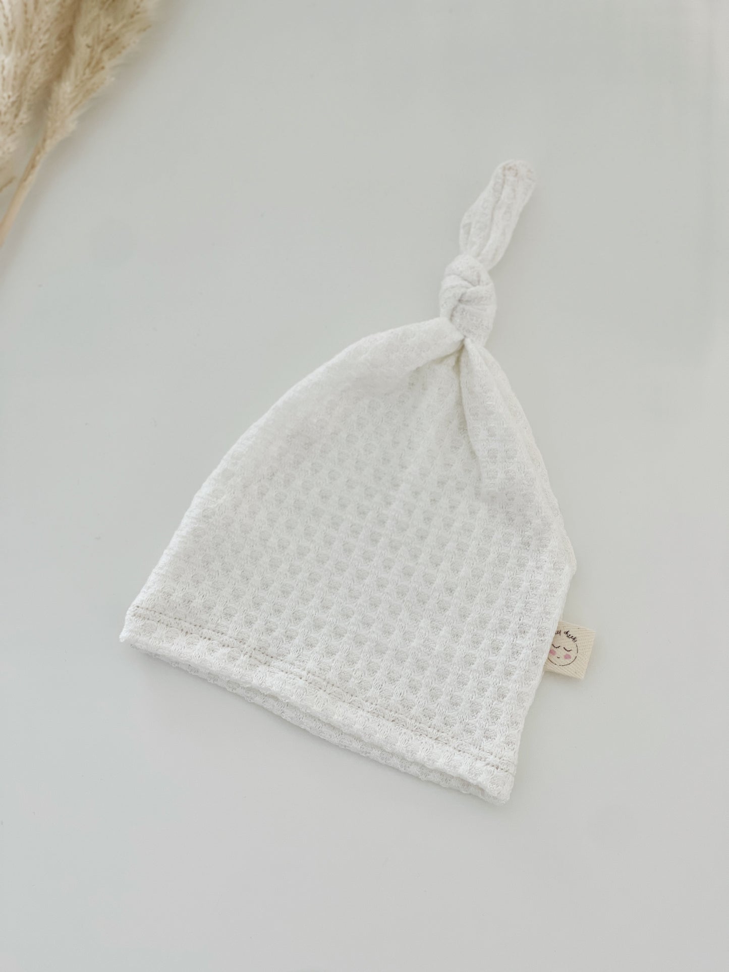 white waffle top knot hat