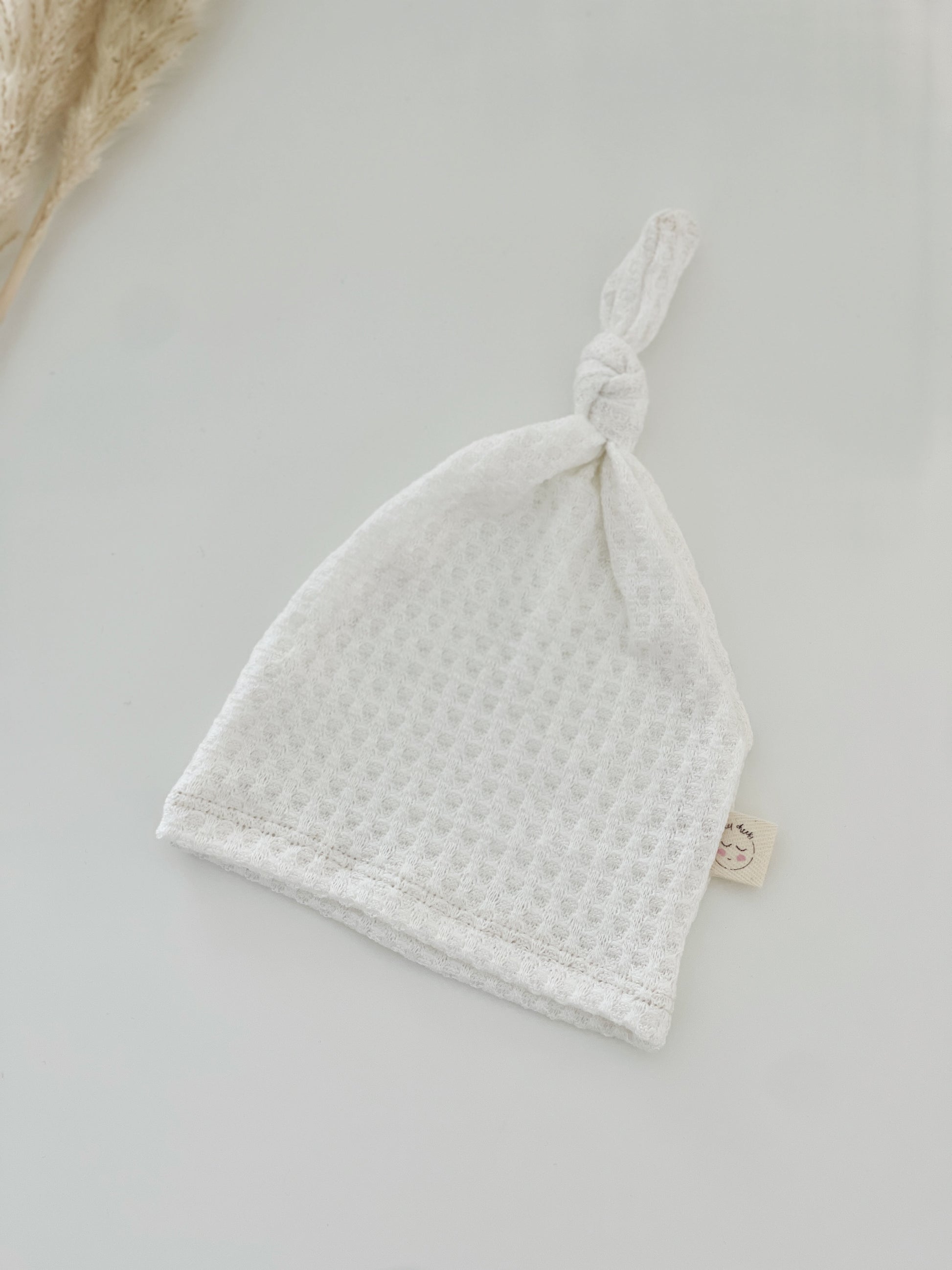 white waffle top knot hat