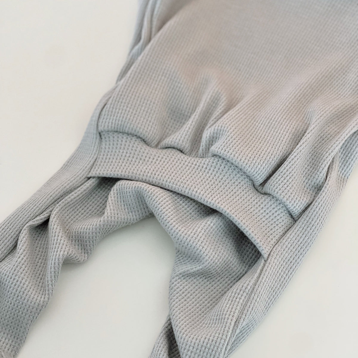 light blue baby boy onesie with a back flap for nighttime changing.