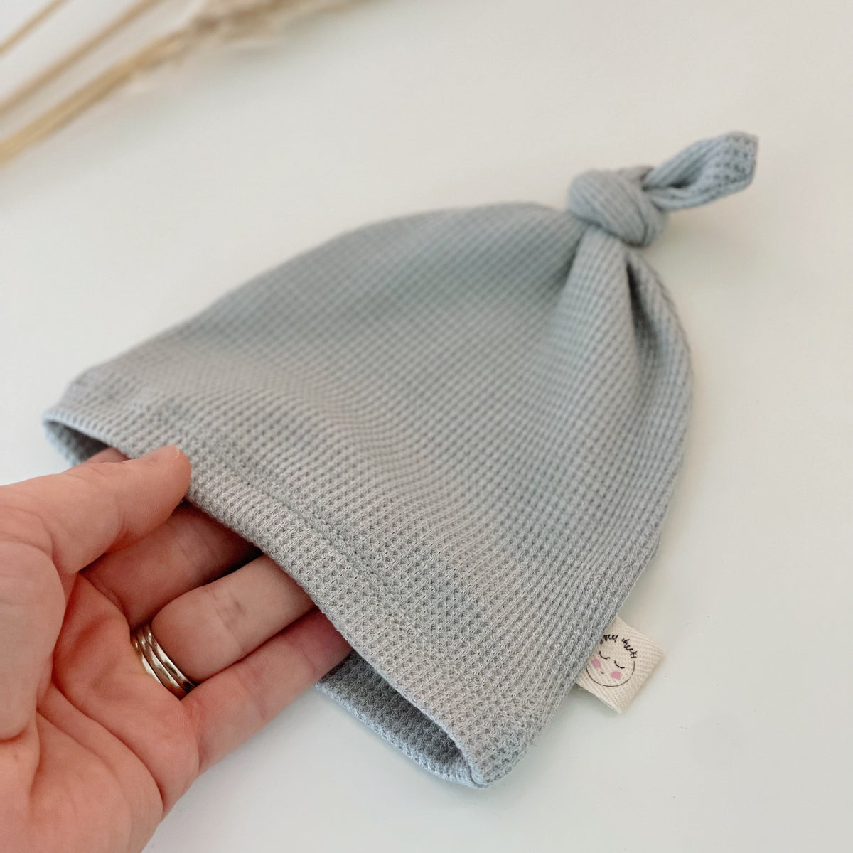 light blue newborn waffle top knot hat