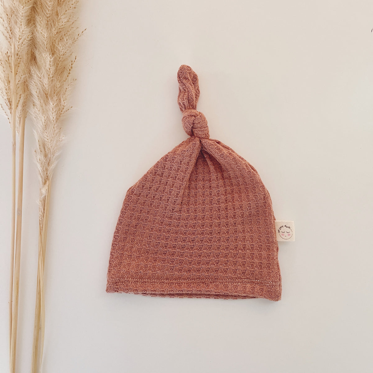 muted pink newborn waffle knotted hat